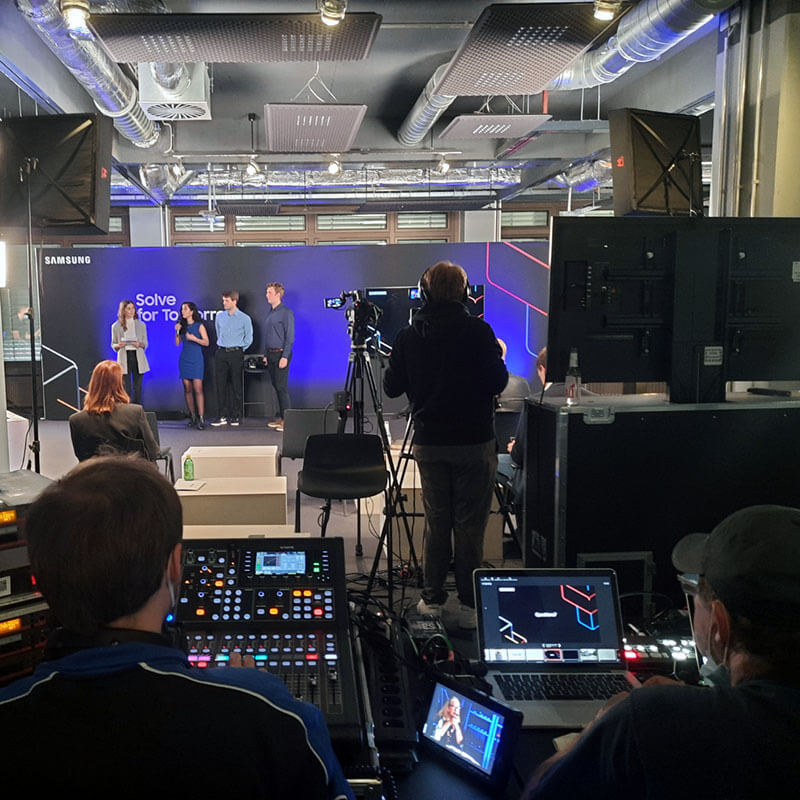 8 Behind-the-scenes view of Samsung Solve for Tomorrow event with stage, presenters and professional live production crew